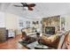 Inviting living room showcases a stone fireplace, fan, and door leading outside at 4008 Cape Vista Dr, Bradenton, FL 34209