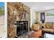 Comfortable living room with stone fireplace and glass door, perfect for relaxation at 4008 Cape Vista Dr, Bradenton, FL 34209