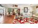Open-concept living room featuring terra-cotta tile, comfortable seating, and decorative rugs at 4008 Cape Vista Dr, Bradenton, FL 34209