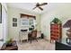 Comfortable home office featuring a work desk, neutral carpet, and a stylish red accent cabinet at 4008 Cape Vista Dr, Bradenton, FL 34209