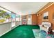 Enclosed patio featuring views of the backyard, with wicker seating and tropical decor at 4008 Cape Vista Dr, Bradenton, FL 34209