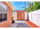A medium sized shed with double doors is located on a graveled area with privacy fence at 4008 Cape Vista Dr, Bradenton, FL 34209