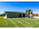 Charming one-story home with a lush green lawn and mature palm tree at 4123 Rock Creek Dr, Port Charlotte, FL 33948