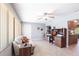 Bright living room featuring tile flooring, a ceiling fan, and a cozy seating area with neutral tones at 4123 Rock Creek Dr, Port Charlotte, FL 33948