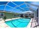 Backyard pool area with lush landscaping and outdoor entertaining space at 4123 Rock Creek Dr, Port Charlotte, FL 33948