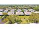 Overhead shot highlights green lawns and mature trees, providing a serene and lush living environment at 4451 Atwood Cay Cir # 7, Sarasota, FL 34233