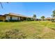 Manicured lawn surrounding condos with a view of mature palm trees at 4451 Atwood Cay Cir # 7, Sarasota, FL 34233