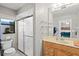 Bathroom featuring a glass shower door, floating shelves, and a light wood vanity at 4451 Atwood Cay Cir # 7, Sarasota, FL 34233