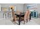Cozy dining area with wicker chairs and view to breakfast bar, creating a welcoming and casual space at 4451 Atwood Cay Cir # 7, Sarasota, FL 34233