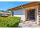 Charming villa entrance, showcases textured exterior and manicured landscaping, leading to a welcoming tiled entryway at 4451 Atwood Cay Cir # 7, Sarasota, FL 34233