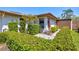Inviting villa boasting mature shrubbery, textured walls, walkway and providing enhanced curb appeal at 4451 Atwood Cay Cir # 7, Sarasota, FL 34233