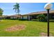 Charming single-story home featuring lush green lawn and mature landscaping for serene curb appeal at 4451 Atwood Cay Cir # 7, Sarasota, FL 34233