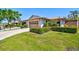 Quaint villa featuring a lush lawn, manicured shrubbery, attached garage, and a cozy neighborhood at 4451 Atwood Cay Cir # 7, Sarasota, FL 34233