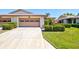 Charming villa showcasing a well-maintained driveway with beautiful shrubbery accents and attached garage, offering curb appeal at 4451 Atwood Cay Cir # 7, Sarasota, FL 34233