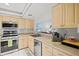 Bright kitchen with stainless steel appliances and light wood cabinets at 4451 Atwood Cay Cir # 7, Sarasota, FL 34233