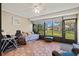 Enclosed lanai featuring tile flooring, ceiling fan, and comfortable seating at 4451 Atwood Cay Cir # 7, Sarasota, FL 34233