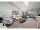 A well-lit living room with neutral tones, skylight, and access to the lanai at 4451 Atwood Cay Cir # 7, Sarasota, FL 34233