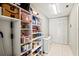 Spacious walk-in pantry with ample shelving and tiled flooring for organized storage at 4451 Atwood Cay Cir # 7, Sarasota, FL 34233