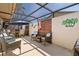 Screened-in patio area complete with lounge chairs, an umbrella, and tasteful decor at 4451 Atwood Cay Cir # 7, Sarasota, FL 34233