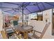 Outdoor patio space with ample seating, a table, and a large sun umbrella at 4451 Atwood Cay Cir # 7, Sarasota, FL 34233