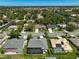 Lovely aerial shot of single-Gathering homes with screened-in pools and water views in a well-maintained neighborhood at 457 Lake Of The Woods Dr, Venice, FL 34293