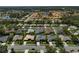 This aerial shows homes with lush lawns and mature landscaping in a tranquil neighborhood close to water features at 457 Lake Of The Woods Dr, Venice, FL 34293