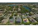 Beautiful aerial view of single-Gathering homes, water features, and lush green landscaping in a desirable neighborhood at 457 Lake Of The Woods Dr, Venice, FL 34293