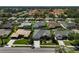A beautiful neighborhood, this aerial shows well-maintained homes, lush landscaping, and manicured lawns at 457 Lake Of The Woods Dr, Venice, FL 34293