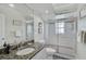 Full bathroom with granite countertops, glass shower, and modern fixtures at 457 Lake Of The Woods Dr, Venice, FL 34293