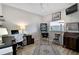 Functional bedroom featuring a desk, pinball machine, and comfortable seating at 457 Lake Of The Woods Dr, Venice, FL 34293