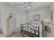 Well-lit bedroom features a bed with a black metal frame, plus a white dresser and closet at 457 Lake Of The Woods Dr, Venice, FL 34293