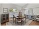 Cozy dining room featuring a round table, cushioned chairs, and stylish furnishings with natural lighting at 457 Lake Of The Woods Dr, Venice, FL 34293