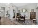 Elegant dining room with a round table, stylish chairs, and a decorative rug next to foyer at 457 Lake Of The Woods Dr, Venice, FL 34293