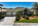 Well-maintained home with a landscaped front yard and two-car garage at 457 Lake Of The Woods Dr, Venice, FL 34293
