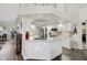 Well-lit kitchen with white cabinets, stainless steel appliances, and stone countertops at 457 Lake Of The Woods Dr, Venice, FL 34293