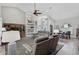 Spacious living room featuring a ceiling fan, large rug, and comfortable seating arrangements at 457 Lake Of The Woods Dr, Venice, FL 34293