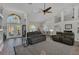 Open-concept living room boasts high ceilings, large windows, neutral tones, and lots of seating space at 457 Lake Of The Woods Dr, Venice, FL 34293