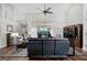 Bright living room features vaulted ceilings, wood floors, comfortable reclining sofas, and a view of the backyard at 457 Lake Of The Woods Dr, Venice, FL 34293