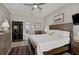 Large primary bedroom features a king-sized bed, wood floors, and dark wood furniture at 457 Lake Of The Woods Dr, Venice, FL 34293