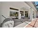 Covered patio features a hammock, seating and access to the home and backyard at 457 Lake Of The Woods Dr, Venice, FL 34293