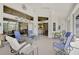 Enclosed patio includes seating, ceiling fan, and views into the home at 457 Lake Of The Woods Dr, Venice, FL 34293