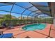 Outdoor in-ground screened pool with lounge chairs for relaxation and a well-maintained pool enclosure at 457 Lake Of The Woods Dr, Venice, FL 34293
