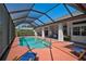 Enclosed pool area with in-ground pool and outdoor seating at 457 Lake Of The Woods Dr, Venice, FL 34293