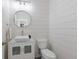 Powder room featuring a modern sink, vanity, shiplap wall and toilet at 4606 Lake Fox Pl, Parrish, FL 34219