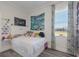 Inviting bedroom with lots of light featuring a large bed, Monet print, vinyl records, and whimsical decor at 4606 Lake Fox Pl, Parrish, FL 34219