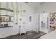 View of a bedroom featuring wood-look floors, an accent wall, and entry into a bathroom at 4606 Lake Fox Pl, Parrish, FL 34219