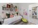 Bedroom daybed featuring colorful decor, cube shelves, and a view into the bathroom at 4606 Lake Fox Pl, Parrish, FL 34219
