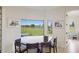 Bright breakfast nook with scenic views of the lake and manicured lawn at 4606 Lake Fox Pl, Parrish, FL 34219