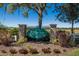 Community entrance featuring a decorative stone sign and lush landscaping at 4606 Lake Fox Pl, Parrish, FL 34219