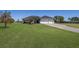 Beautiful home with a sprawling lawn, three car garage, and mature trees at 4606 Lake Fox Pl, Parrish, FL 34219